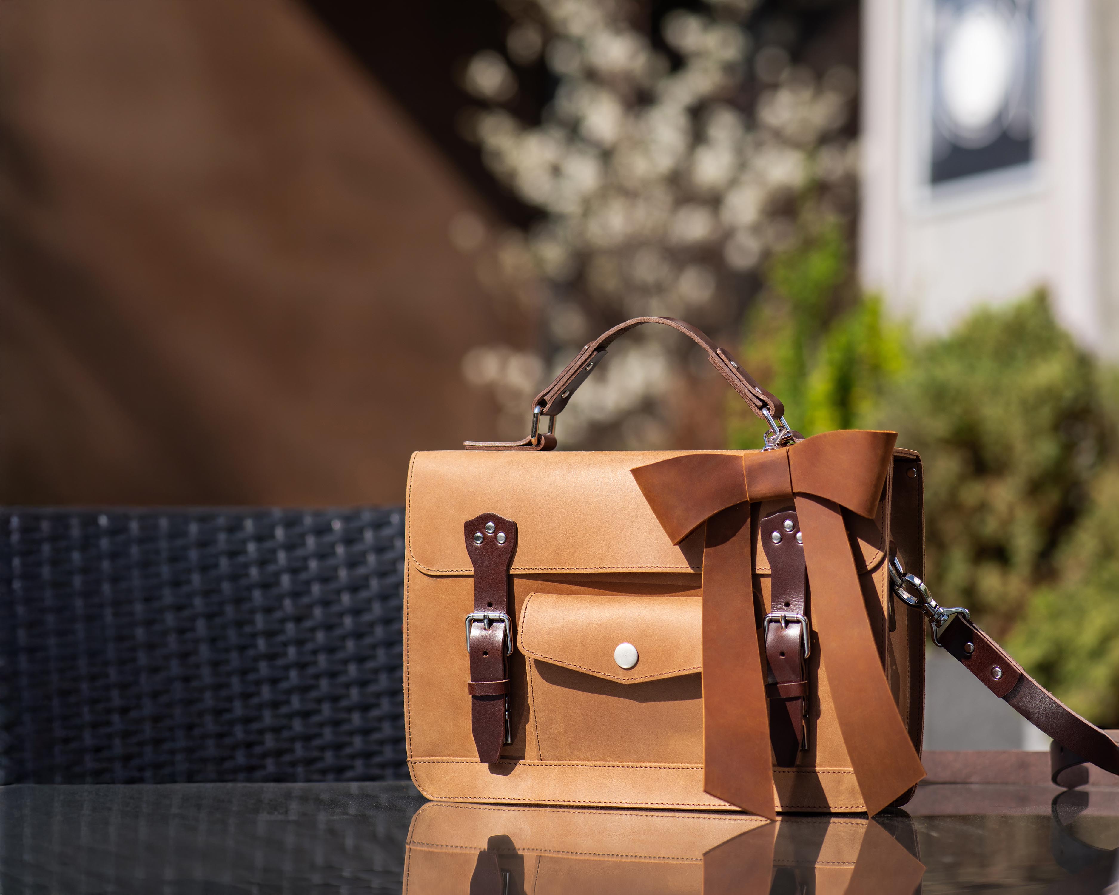 bow on leather bag