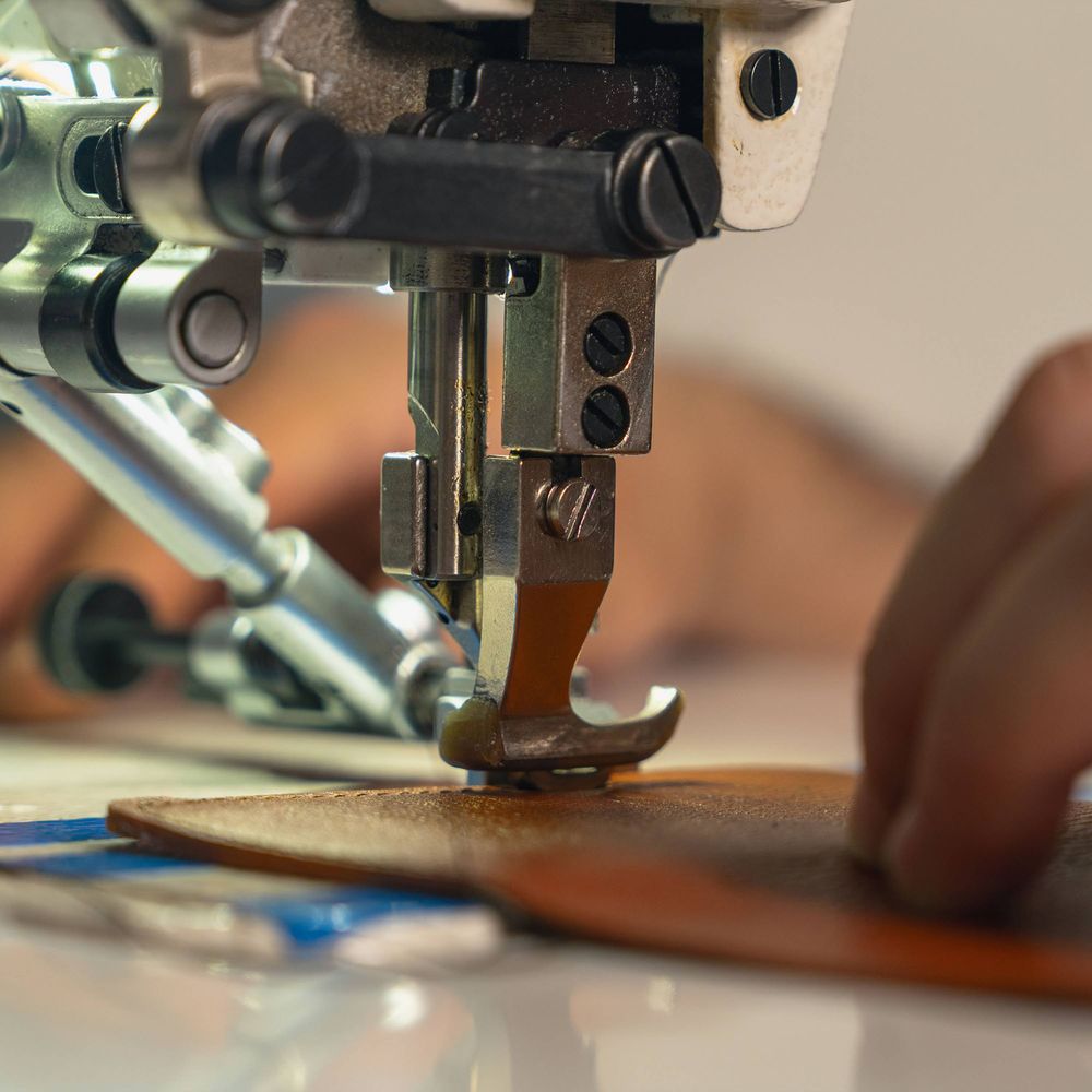 Machine stitching a leather piece in the Hidemont workshop